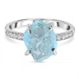 A 925 silver ring set with a rough aquamarine and white stone set shoulders.