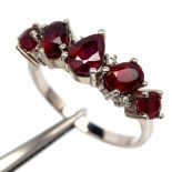 A 925 silver ring set with pear and oval cut rubies, (O).
