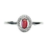 A 925 silver ring set with an oval cut ruby and white stones, (O.5).