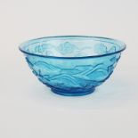 A Chinese relief decorated blue Peking glass bowl, Dia. 16cm. D. 7cm.