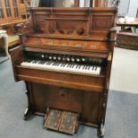 A Chicago Boyd Organ Co. London harmonium with carved decoration, H. 143cm W. 103cm.