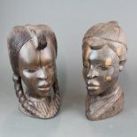 Two large African carved figured ebony busts, H. 28cm.