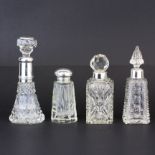 A group of four hallmarked silver mounted cut glass dressing table bottles, tallest 13.5cm.