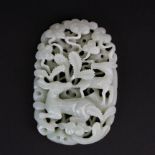A finely carved Chinese celadon jade panel, probably originally on the top of a box, decorated