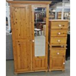 A pine wardrobe with mirror fronted door together with two matching pine bedside cabinets,