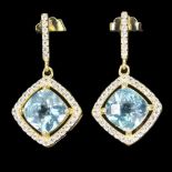A pair of gold on 925 silver drop earrings set with cushion cut blue topaz and white stones, L. 2.