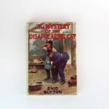 A 1944 edition of 'The mystery of the disappearing cat' by Enid Blyton with ink dedication by the