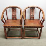 A pair of Chinese stained hardwood horseshoe chairs with carved decoration to back panel, H. 85cm.