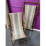 A pair of mid 20th century folding deck chairs, folded L. 138cm.