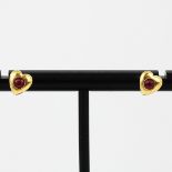 A pair of 9ct yellow gold ruby set heart shaped stud earrings, L. 7mm.