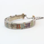 A Russian .88 silver and gilt enamelled hinged horse shoe bangle, H. 6.5cm. Slightly A/F.