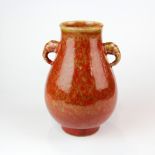 A Chinese red glazed porcelain vase with elephant head handles. Six character mark to base, H.