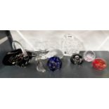 A group of paperweights and coloured glassware including Caithness.