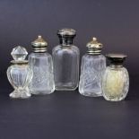 A group of hallmarked silver mounted cut glass bottles.