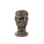 A small French bronze multi headed seal, H. 6cm.