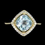 A gold on 925 silver ring set with cushion cut blue topaz and white stones, (P).