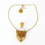 An 18ct yellow gold perfume bottle holder, H. 9.5cm, and chain with a half sovereign.