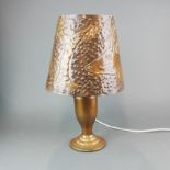 An arts and crafts hammered copper table lamp, H. 48cm.