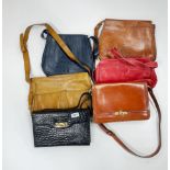 A group of vintage leather bags.