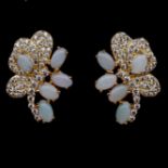 A pair of gold on 925 silver earrings set with cabochon cut opals and white stones, L. 21cm.