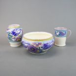 Three Poole pottery items, bowl dia. 20cm, vase H. 15cm.