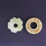 Two Chinese carved jade discs, largest dia. 5.3cm.