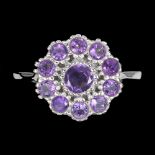 A 925 silver cluster ring set with round cut amethysts, (P).
