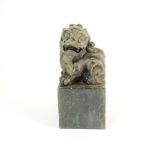 A Chinese carved stone seal mounted with a lion dog, H. 12.5cm.