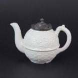 A small 19th century English relief decorated porcelain teapot with hinged pewter lid and