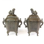 A pair of early 20th century bronze censers with elephant head handles and lion dog knops.