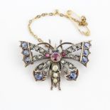 A white metal butterfly shaped brooch set with diamonds, sapphires, rubies and seed pearls, 3.5 x