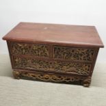 A Chinese three drawer cabinet with carved and gilt relief decoration, 80 x 49 x 40cm.