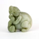 A Chinese carved jade figure of a young dragon with a bird, H. 6cm.