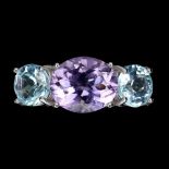 A 925 silver ring set with cushion cut blue topaz and amethyst, (O.5).