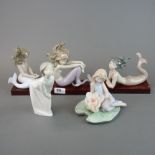 Three Lladro figures of mermaids with wooden stand and boxes together with a Lladro figure of a girl