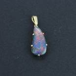 A 9ct gold mounted pendant set with a large black opal, L. 2cm.