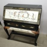 A Chinese carved hardwood two drawer, drop down bureau with hand painted and figural relief