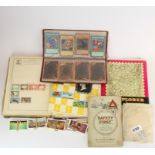 A collection of stamps and cigarette cards.