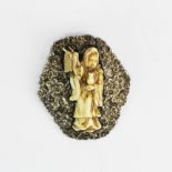 An early 20th century Chinese silver and carved bone brooch of the Goddess Guanyin, H. 5.5cm.