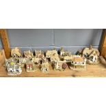 A quantity of Lilliput lane cottages with boxes.