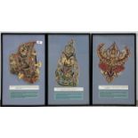 A framed set of three Thai cut goat skin shadow puppet style figures, 32 x 53cm.