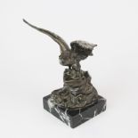 A bronzed metal figure of an eagle on a marble base, H. 19cm.