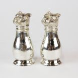 A pair of silvered metal dog head pepper pots, H. 10.5cm.