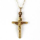 A 9ct yellow gold chain with a 9ct crucifix pendant, chain L. 48cm.