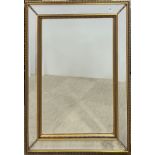 A large gilt framed bevelled glass mirror, 87 x 118cm.