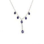 A silver and gold mounted necklace set with oval cut sapphires and diamonds, L.39cm.