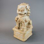 A large Chinese celadon glazed porcelain lion dog figure, H. 38cm.