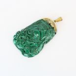 An early 20th century gilt white metal (tested silver) mounted Chinese carved malachite pendant,