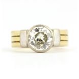 An 18ct yellow and white gold ring set with a large old cut diamond, estimated approx. 2.4ct, (Q).