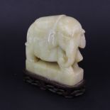 A 19th/early 20th century Chinese carved soapstone model of an elephant on a carved hardwood base,
